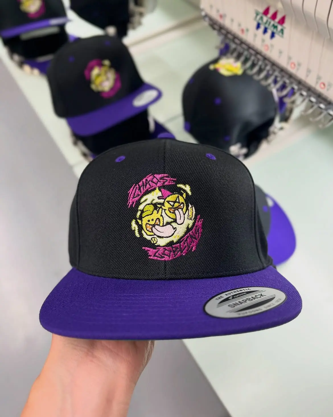 Black and purple snapback with a cat character