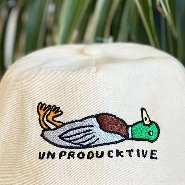 Cream cap with an Unproductive duck embroidery
